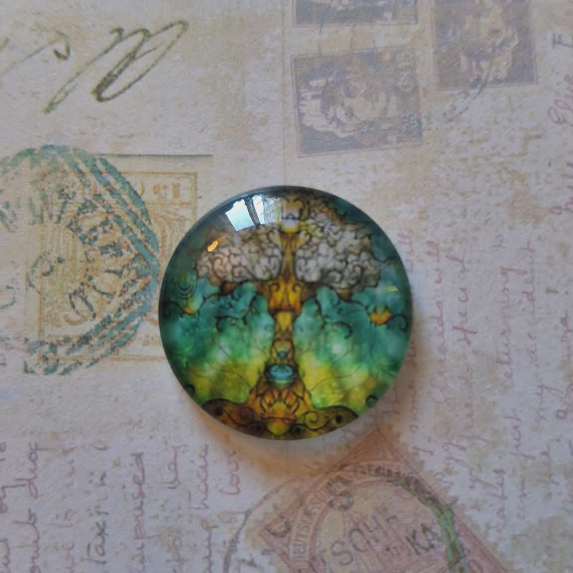 Round decorative item with artistic design on a textured surface with vintage stamps