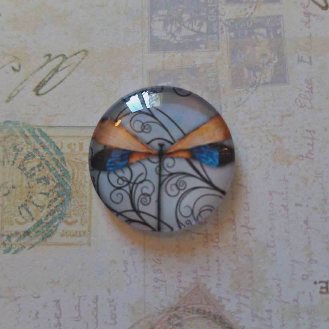 Decorative button with a bow design on a vintage letter background