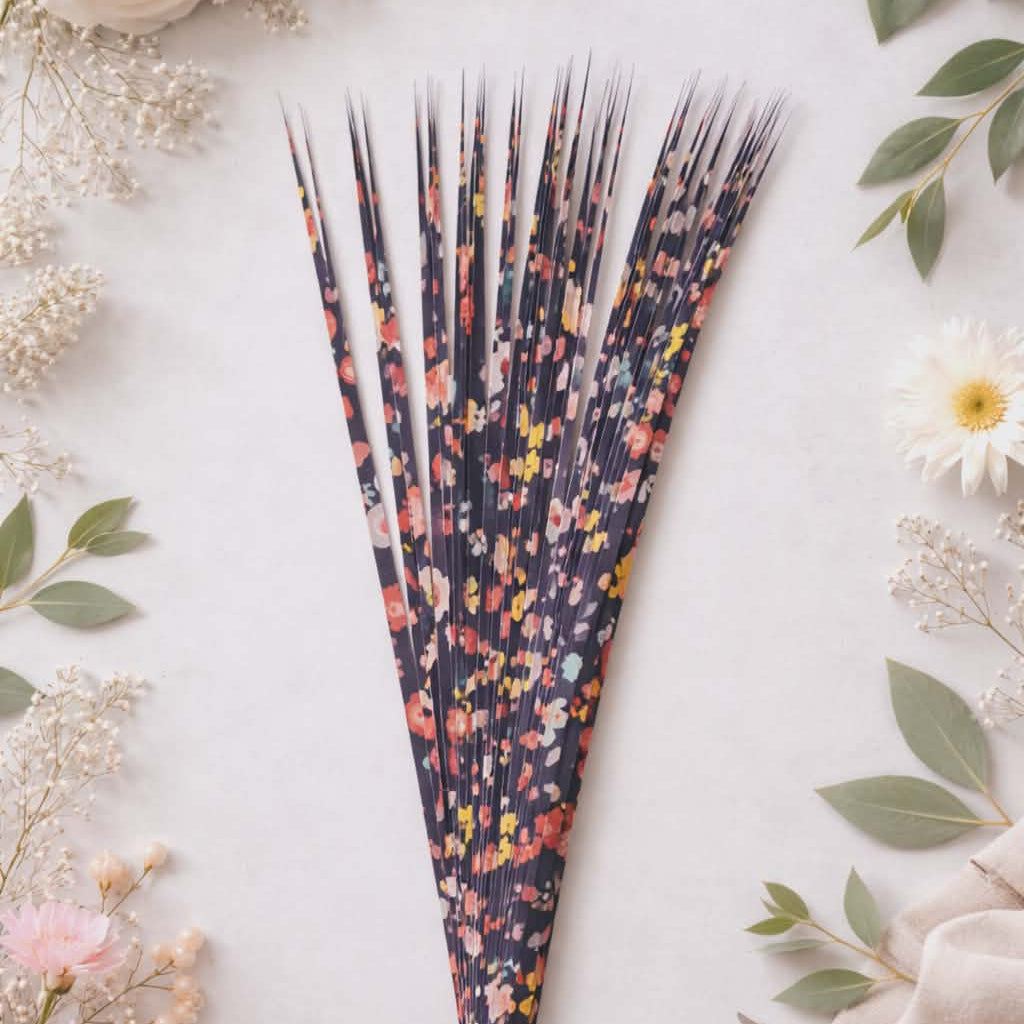 Decorative precut paper strips with floral pattern on a light background with flowers and scissors