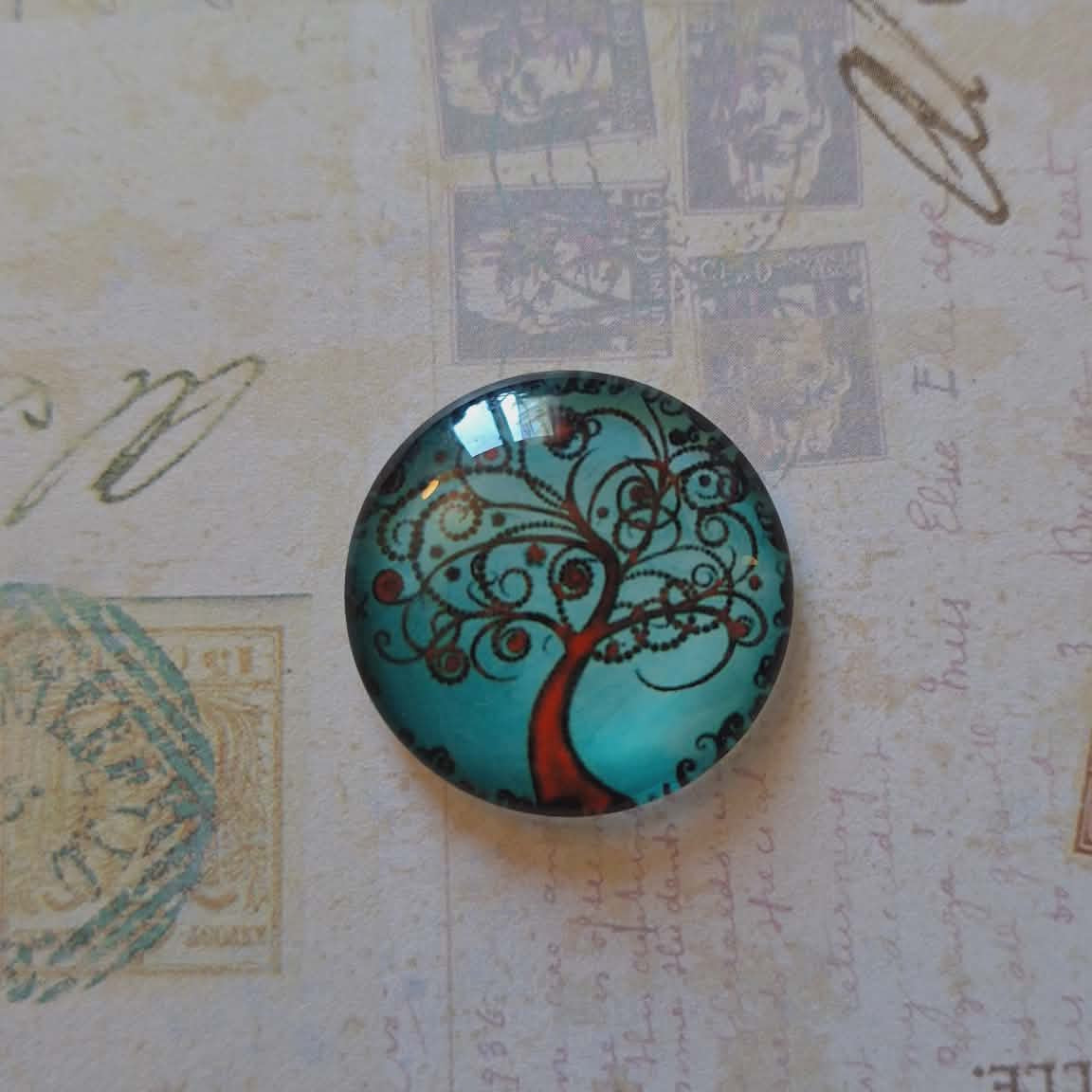 Round decorative item with tree design on a textured background