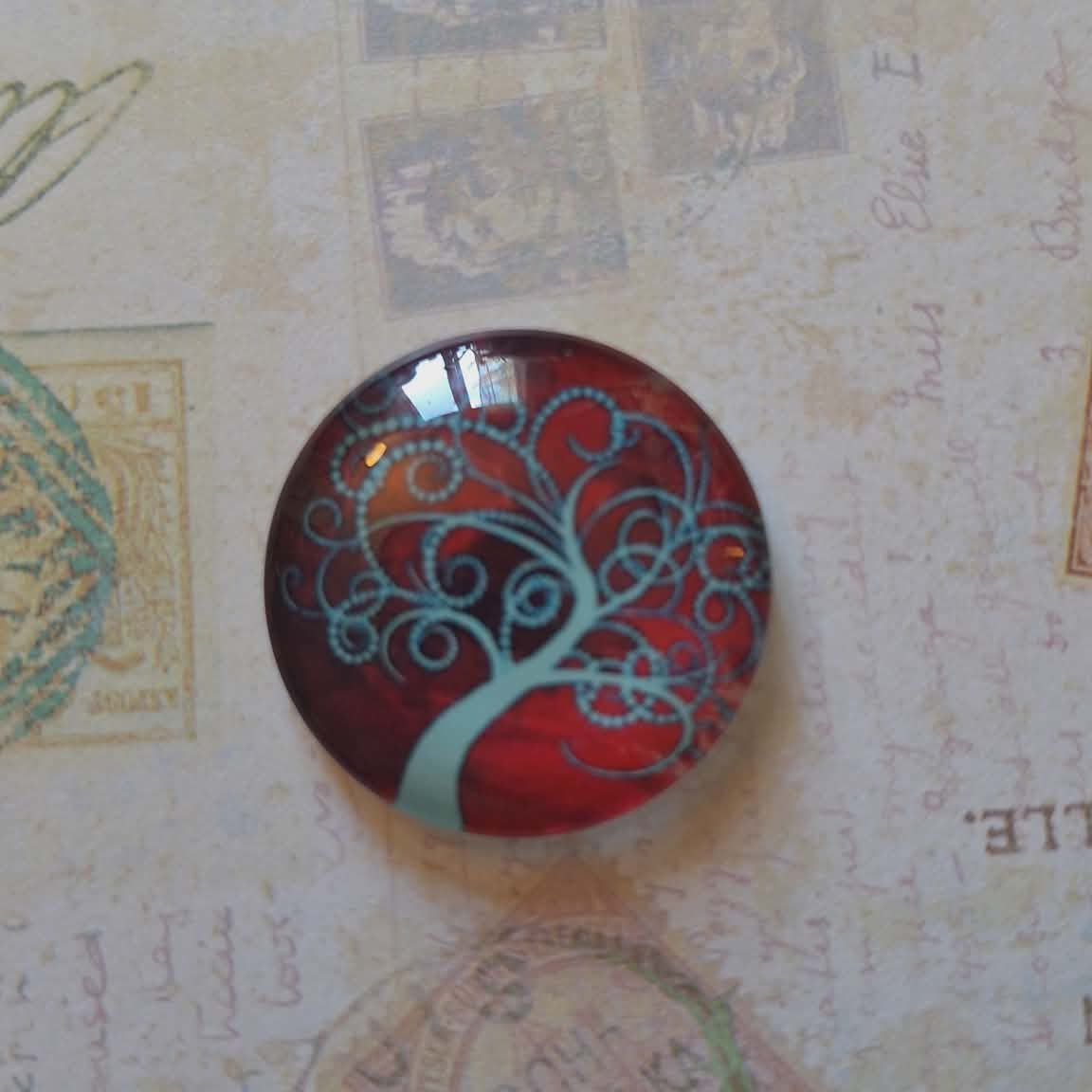 Round decorative item with tree design on a textured background