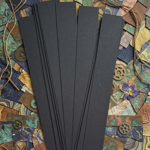 Black 16 mm barrel-shaped paper bead strips on creative paper scraps background