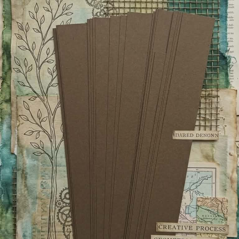 Brown 16 mm barrel-shaped paper bead strips on tie-dye paper scrap with twine