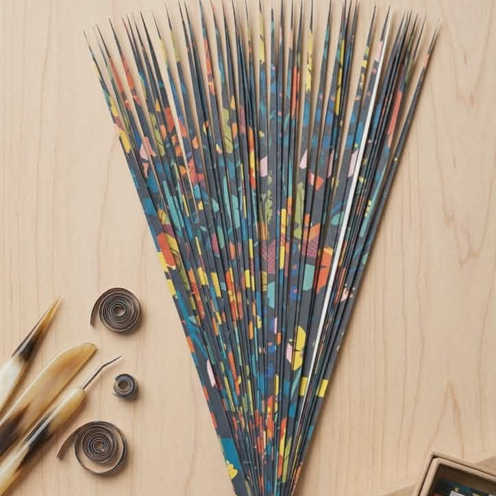 Colorful precut paper strips with decorative colors on a wooden surface