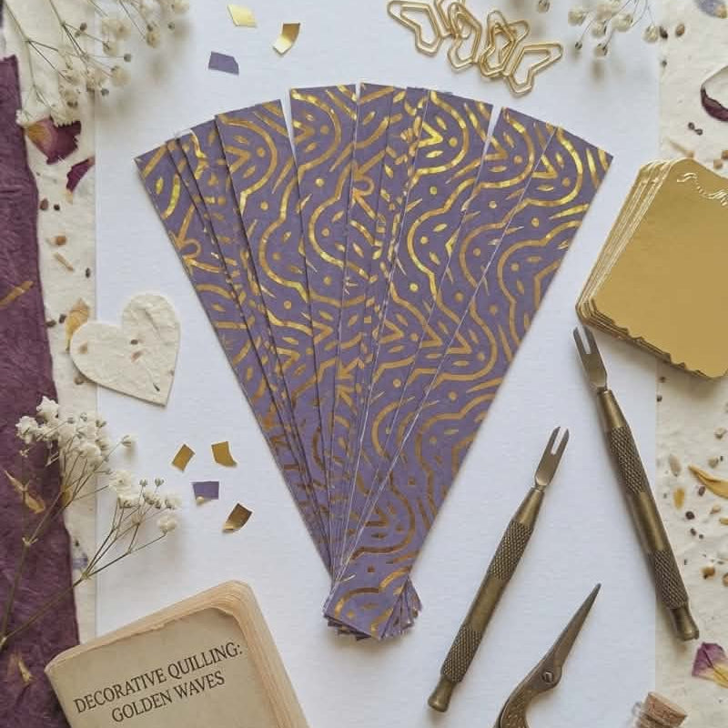 Decorative quilling materials with tools and patterns on a textured surface