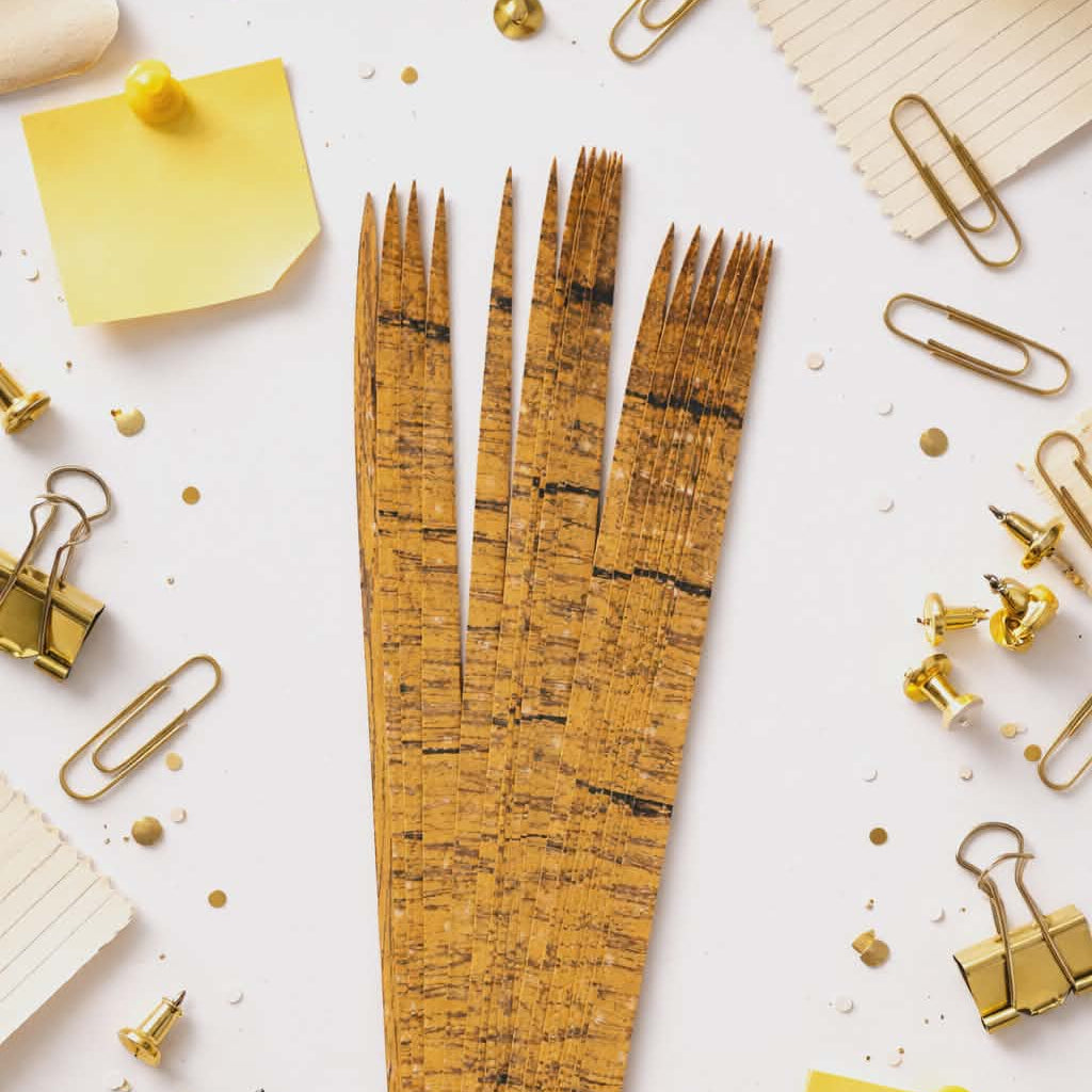 Gold cork paper bead rolling strips for DIY jewelry making in styled flat lay