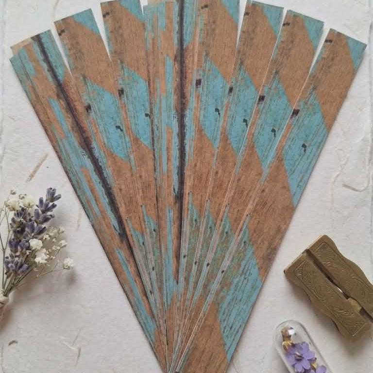 Decorative wooden fan with floral elements on a light background