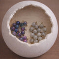 Close-up of violet iridescent rosary beads with gray stone accents for DIY Catholic rosary kit